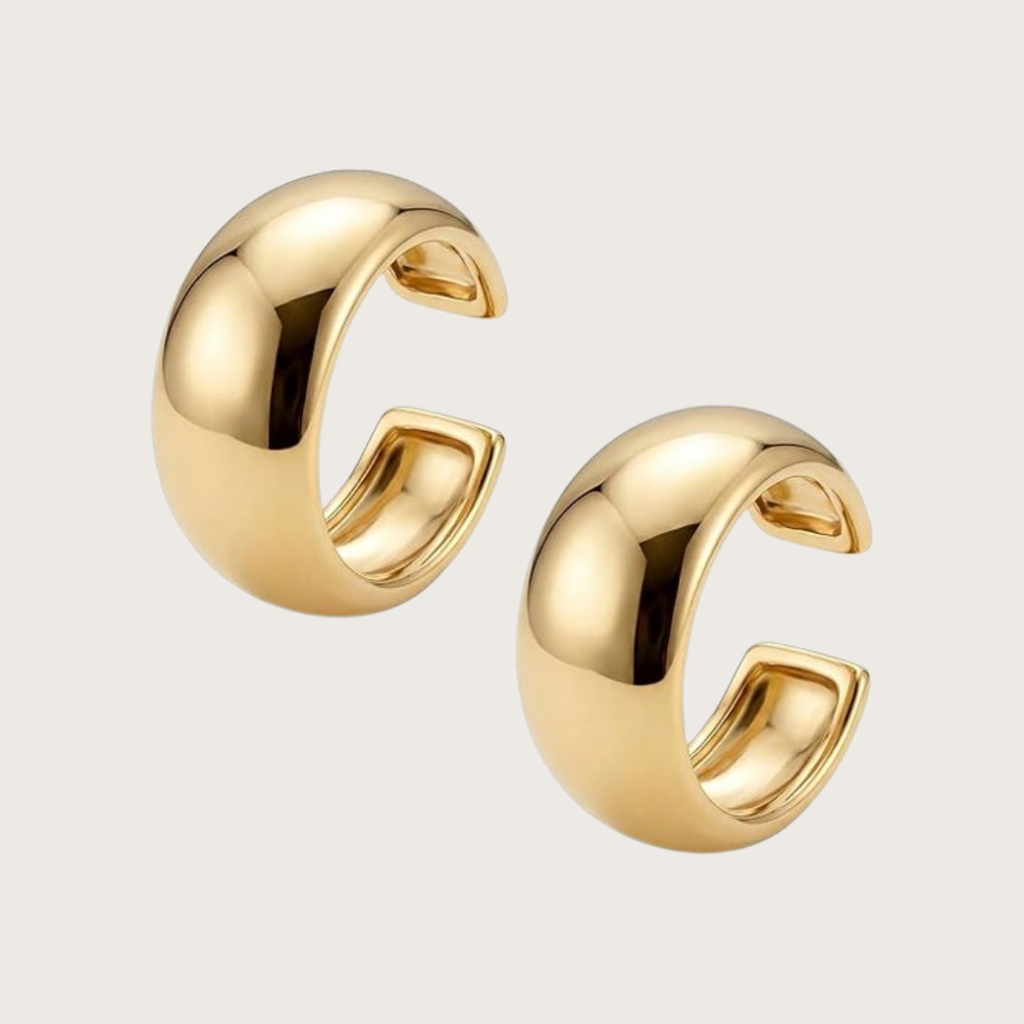 Gold hoop earrings on a light gray background